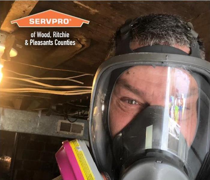 a SERVPRO staff member wearing a full face gas mask