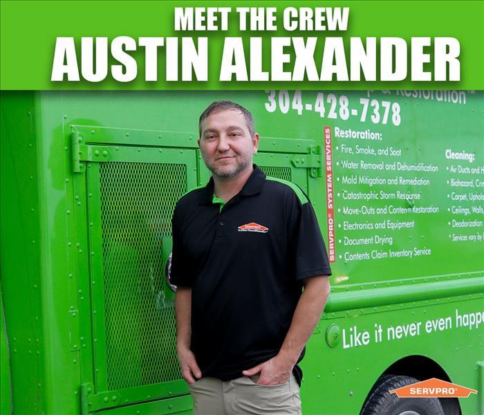 Austin Alexander standing in front of a servpro truck